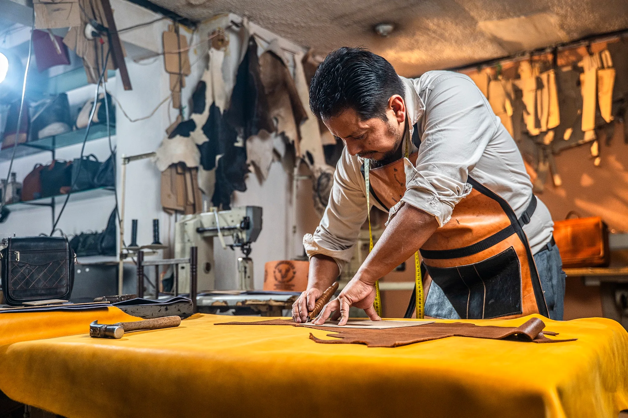 Artesano de cuero en Cotacachi trabajando una pieza en su taller